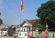 Bhabinkamtibmas Mesuji Bagikan Bendera ke Warga