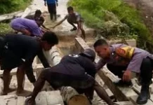 Bhabinkamtibmas bersama Warga Tri Wacu Wacu Gotong Royong Perbaiki Jembatan