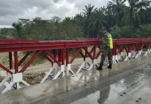 Babinsa Kodim 0103/Aut Intensifkan Patroli Infrastruktur Pasca Banjir