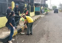 Babinsa Koramil Serui Bersama Warga Bersihkan Bahu Jalan