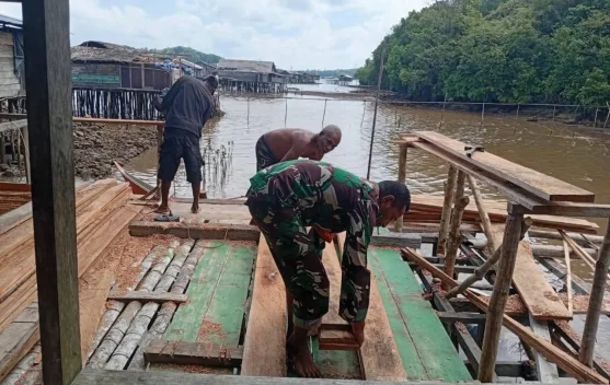 Babinsa Ansus Bantu Warga Pasang Dinding Rumah