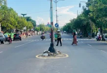 Personel Satlantas Polresta Sumenep Membantu Warga Menyeberang di Area Pasar